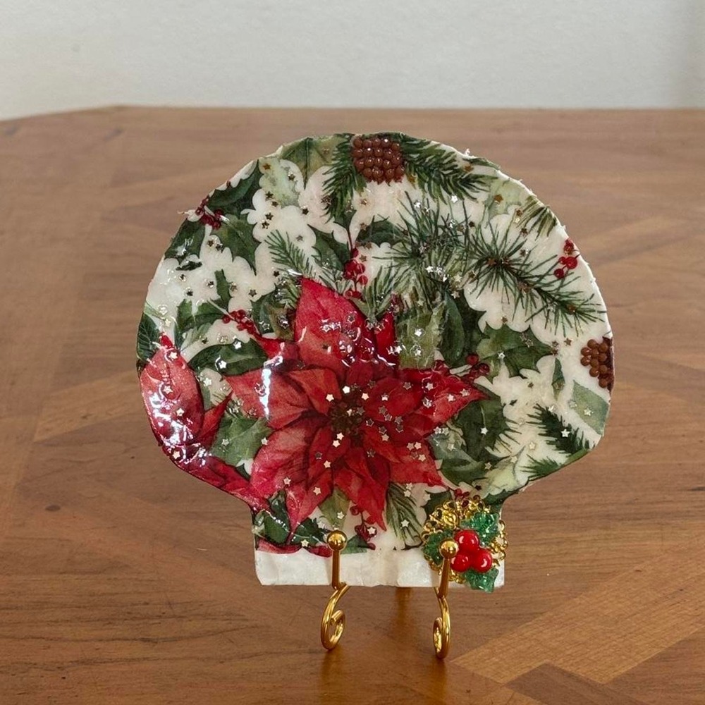Christmas decoupage with red poinsettia flowers, green leaves and pinecones